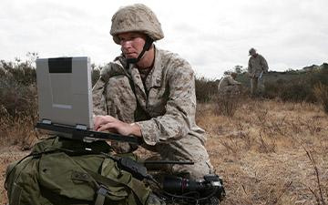 Warfighter in a field utilizing satcom on the move to communication on a laptop